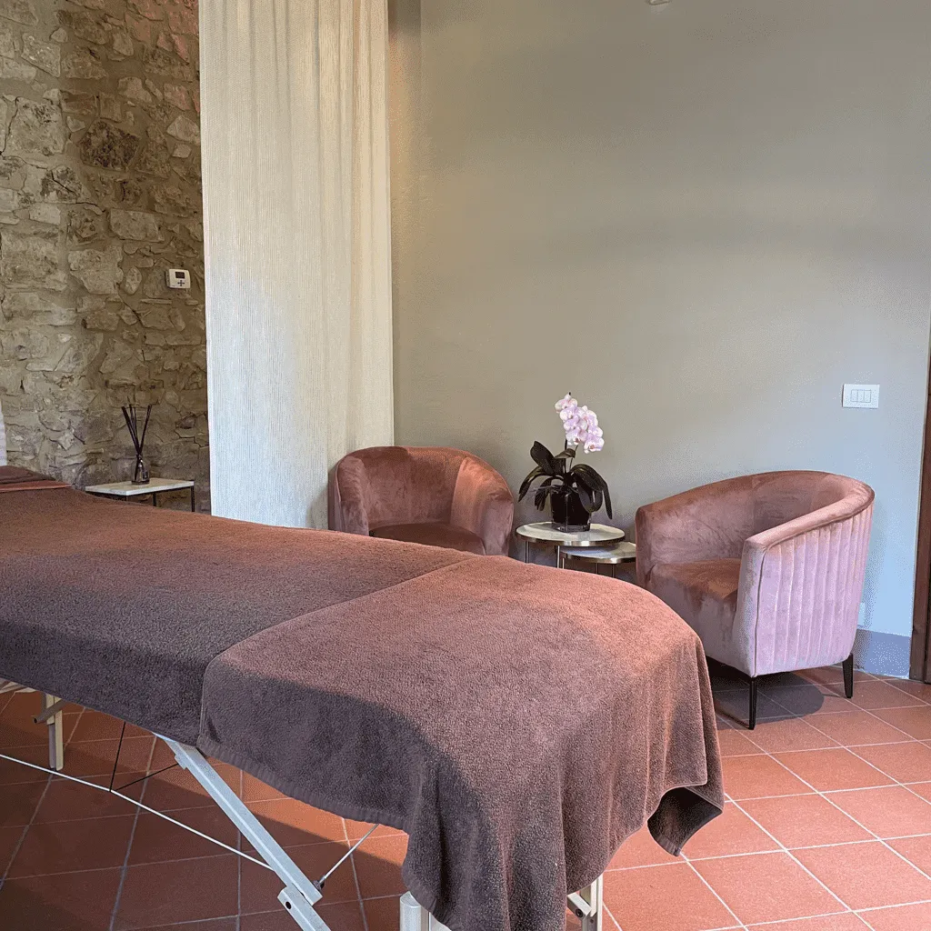 La stanza per i trattamenti con il lettino e le poltrone rosa